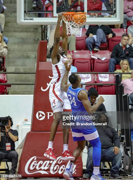 Charles Bediako of the Alabama Crimson Tide throws down a dunk over Oscar Tshiebwe of the Kentucky Wildcats during the first half at Coleman Coliseum...