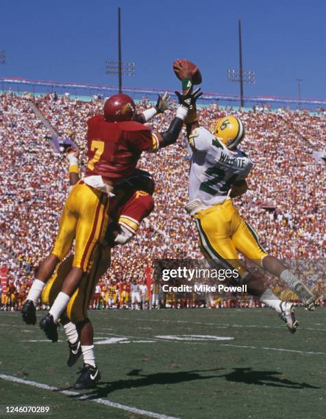 Randy Willhite, Running Back for the University of Oregon Ducks jumps in the air to catch the football from Mark Carrier, Safety for the University...