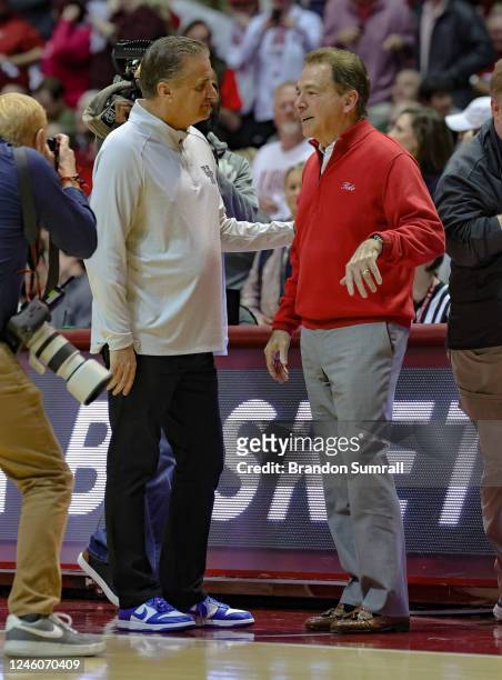 Head coach John Calipari of the Kentucky Wildcats is greeted by head football coach Nick Saban of the Alabama Crimson tide prior to tip off at...