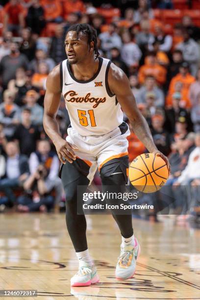 Oklahoma State Cowboys guard John-Michael Wright brings the ball up court during the first half against the Texas Longhorns on January 7th, 2023 at...
