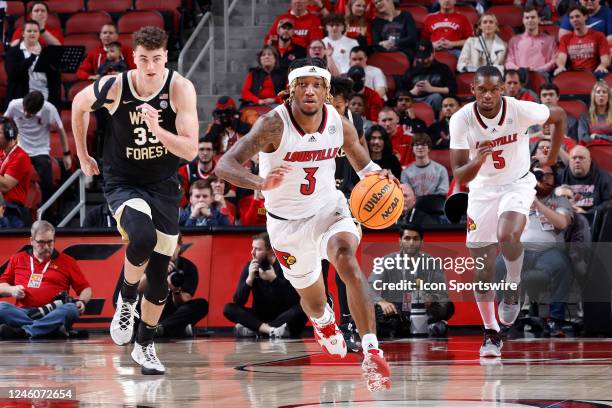 Louisville Cardinals guard El Ellis brings the ball up court ahead of Wake Forest Demon Deacons forward Matthew Marsh during a college basketball...