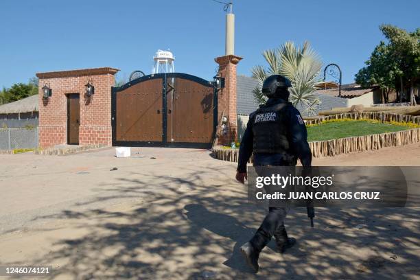 Police officer walks outside the mansion where Ovidio Guzman, aka "El Raton" , son of jailed drug trafficker Joaquin "El Chapo" Guzman, was arrested...