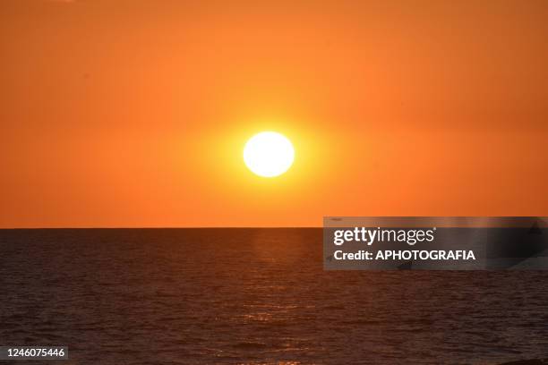 View of the sun as it sets on the Salvadoran coast on January 07, 2023 in La Paz, El Salvador.