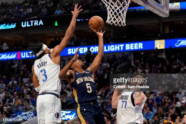 Herbert Jones of the New Orleans Pelicans drives toward the basket between Jaden Hardy and Luka Doncic of the Dallas Mavericks during the second half...