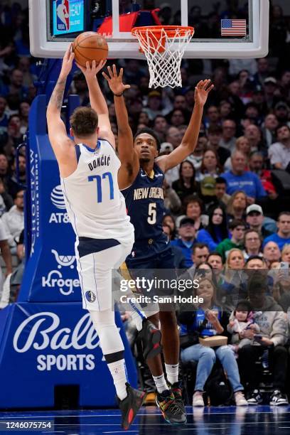 Luka Doncic of the Dallas Mavericks attempts a shot over Herbert Jones of the New Orleans Pelicans during the second half at American Airlines Center...