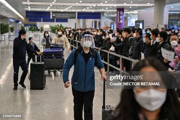 Passengers are seen in the arrivals area for international flights at the Shanghai Pudong International Airport in Shanghai on January 8, 2023. -...