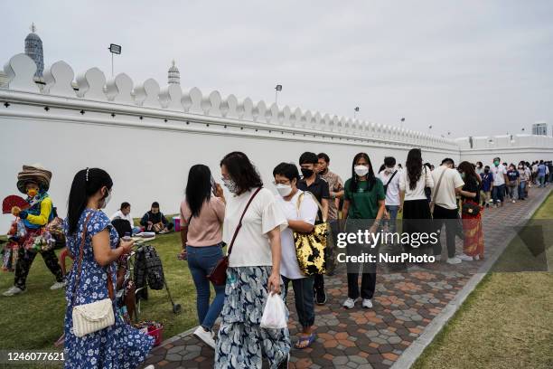 Tourists walk on street outside the Temple of the Emerald Buddha Temple inside the Grand Palace in Bangkok, Thailand, 08 January 2023. Thailand is...