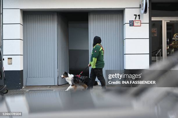 Dog walker passes the entrance to a house in Castrop-Rauxel, western Germany, January 8 where police arrested a 32-year-old Iranian man on suspicion...