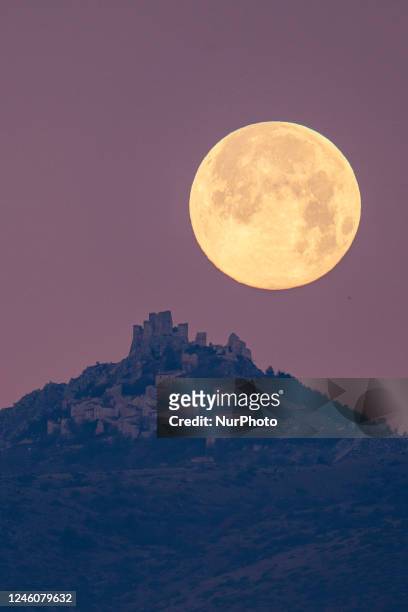 Wolf moon sets behind Rocca Calascio castle and village in Calascio, Italy, on January 7, 2023. The first full moon of the year is often called the...
