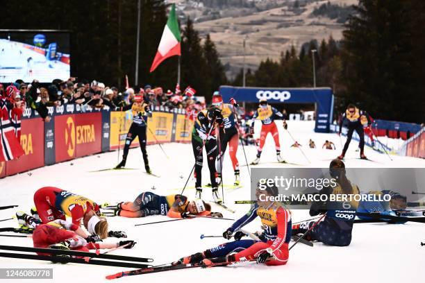 France's Juliette Ducordeau and fellow athletes react after crossing the finish line of the Women's Mass Start 10 km Free event at the FIS Tour de...