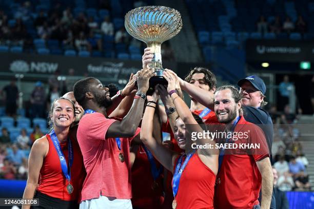 Team US celebrates with the winning trophy of the United Cup after their finals against Italy in Sydney on January 8, 2023. - -- IMAGE RESTRICTED TO...
