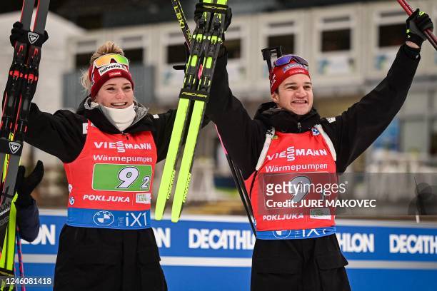 Switzerlands Amy Baserga and Niklas Hartweg celebrate after placing third in the Single Mixed Relay competition of the IBU Biathlon World Cup in...