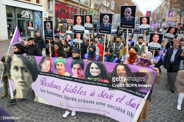Kurdish protesters hold a banner and placards with photos of victims during the demonstration. The Kurdish community of France gathered to pay a...