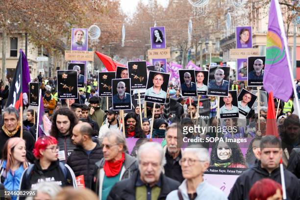 Kurdish protesters hold flags and placards with photos of victims during the demonstration. The Kurdish community of France gathered to pay a tribute...