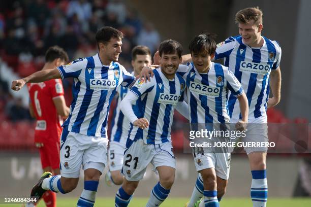 Real Sociedad's Spanish midfielder David Silva celebrates after scoring with his teammates during the Spanish league football match between UD...
