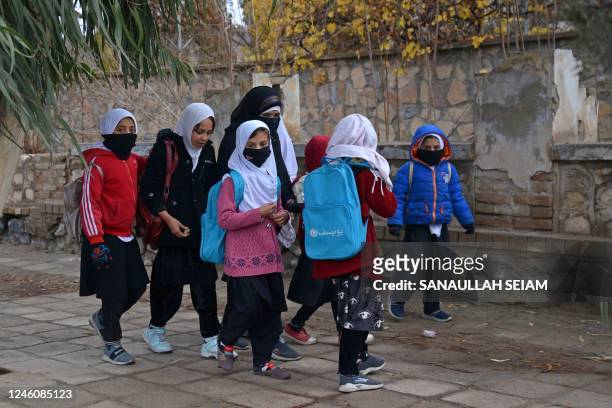 Afghan schoolgirls walk along a street in Kandahar on January 8, 2023.