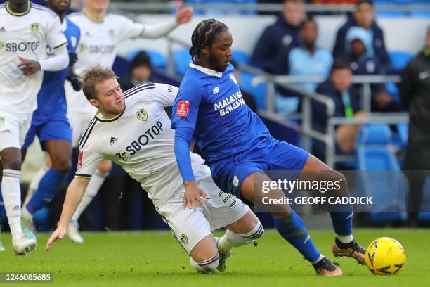 Leeds United's English striker Joe Gelhardt vies with Cardiff City's St Kitts and Nevis midfielder Romaine Sawyers during the English FA Cup third...
