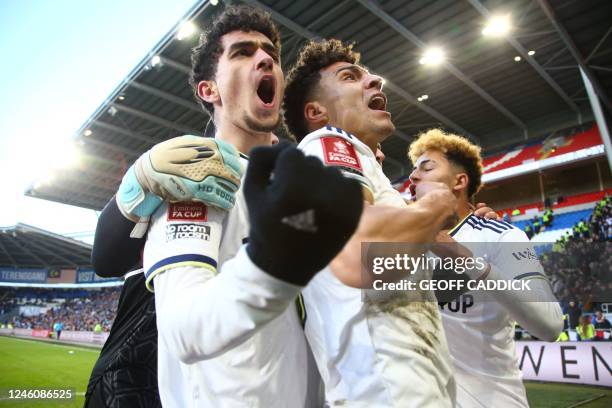 Leeds United's English striker Sonny Perkins celebrates with Leeds United's Brazilian-born Spanish striker Rodrigo and Leeds United's Spanish striker...