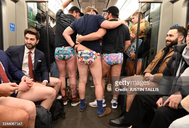 People take part in the annual 'No Trousers On The Tube Day' on the London Underground in central London on January 8, 2023. - 2023 sees the 12th...