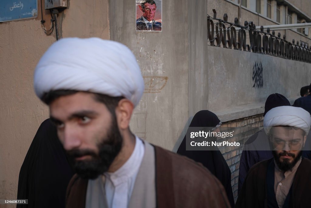 Two Iranian clerics walk past a caricature of the French President... News  Photo - Getty Images