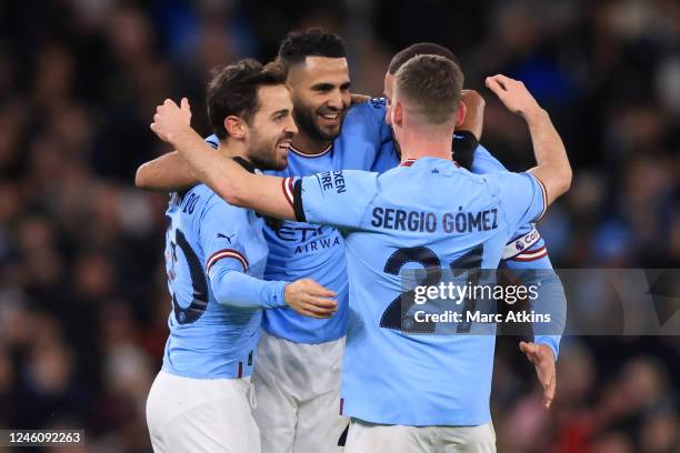 Riyad Mahrez of Manchester City celebrates scoring the opening goal with Bernardo Silva and Sergio Gomez during the Emirates FA Cup Third Round match...