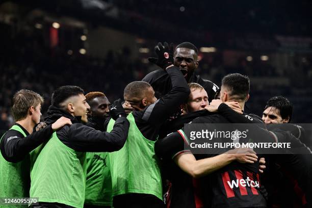 Milan's Italian midfielder Tommaso Pobega celebrates with teammates after scoring during the Italian Serie A football match between AC Milan and AS...