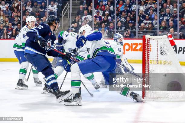 Morgan Barron of the Winnipeg Jets scores into the open net for a second period goal against the Vancouver Canucks at the Canada Life Centre on...