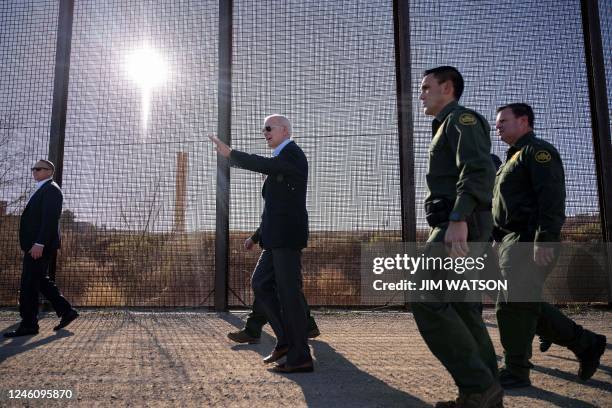 President Joe Biden walks along the US-Mexico border fence in El Paso, Texas, on January 8, 2023. - Biden went to the US-Mexico border on Sunday for...