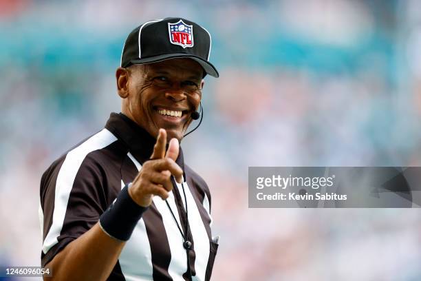 Line judge Carl Johnson smiles and points to a fan during the third quarter of an NFL football game between the Miami Dolphins and the New York Jets...