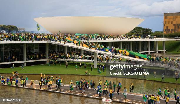 Supporters of Brazilian former President Jair Bolsonaro invade the National Congress in Brasilia on January 8, 2023. - Hundreds of supporters of...