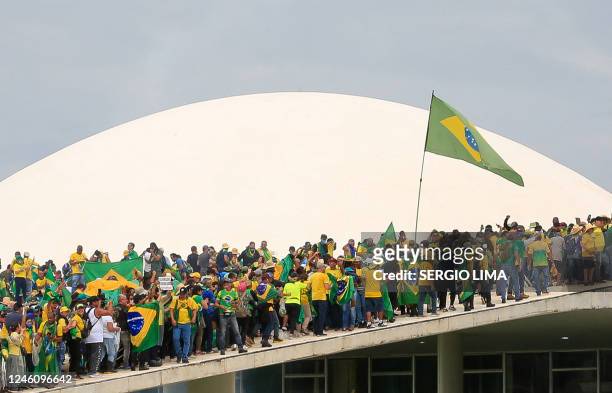 Supporters of Brazilian former President Jair Bolsonaro invade the National Congress in Brasilia on January 8, 2023. Hundreds of supporters of...