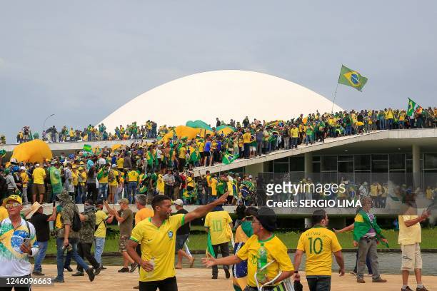 Supporters of Brazilian former President Jair Bolsonaro invade the National Congress in Brasilia on January 8, 2023. - Hundreds of supporters of...