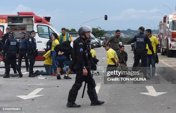 Security forces arrest supporters of Brazilian former President Jair Bolsonaro after retaking control of Planalto Presidential Palace in Brasilia on...