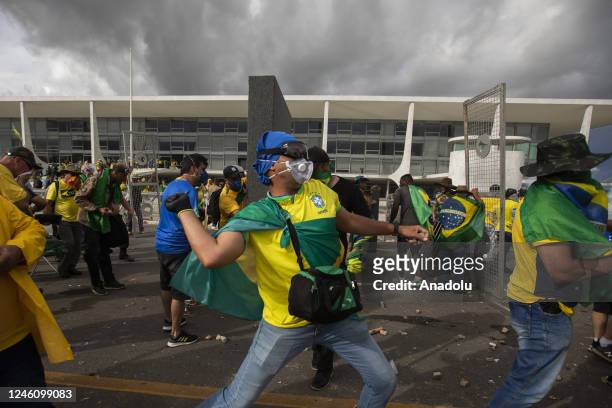 Supporters of former President Jair Bolsonaro clash with security forces as they break into Planalto Palace and raid Supreme Court in Brasilia,...