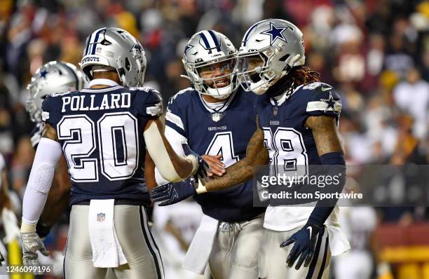Cowboys running back Tony Pollard and quarterback Dak Prescott congratulate wide receiver CeeDee Lamb after his touchdown catch during the Dallas...
