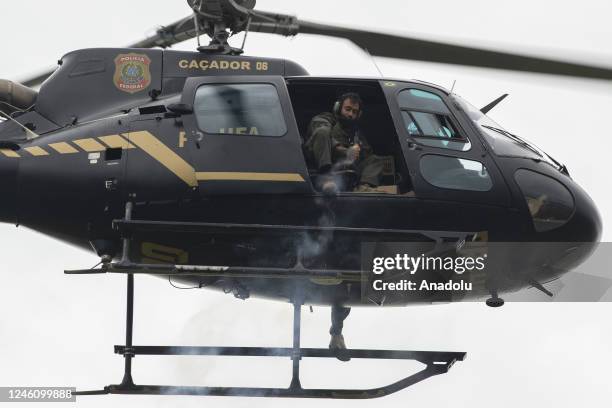 Helicopter flies as supporters of former President Jair Bolsonaro clash with security forces after raiding the National Congress in Brasilia, Brazil,...