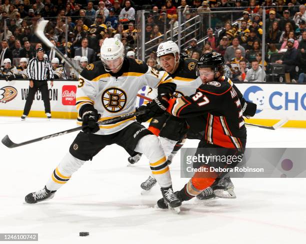 Charlie Coyle of the Boston Bruins and Mason McTavish of the Anaheim Ducks during the first period at Honda Center on January 8, 2023 in Anaheim,...