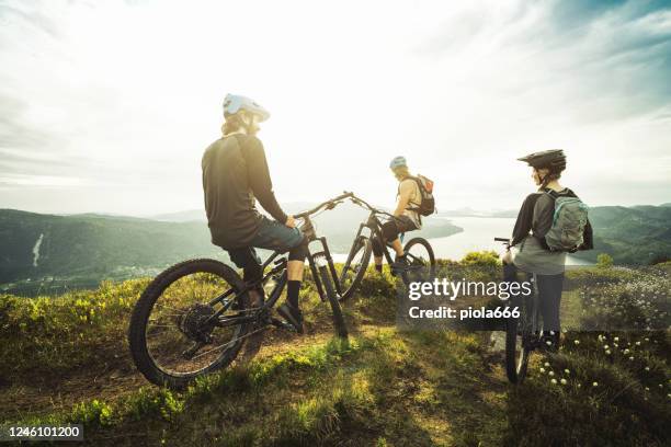 group of friends mountainbike riders: mtb biking outdoor up mountain of norway - mountain biker stock pictures, royalty-free photos & images