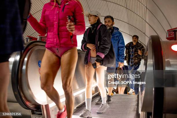 Participants of the "No Trousers Tube Ride" are seen walking inside the London Underground station. "No Trousers Tube Ride" returned to London since...