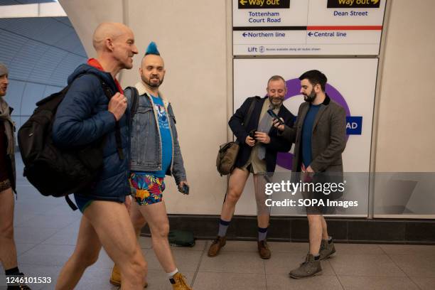 Participants of the "No Trousers Tube Ride" are seen walking inside the London Underground station. "No Trousers Tube Ride" returned to London since...