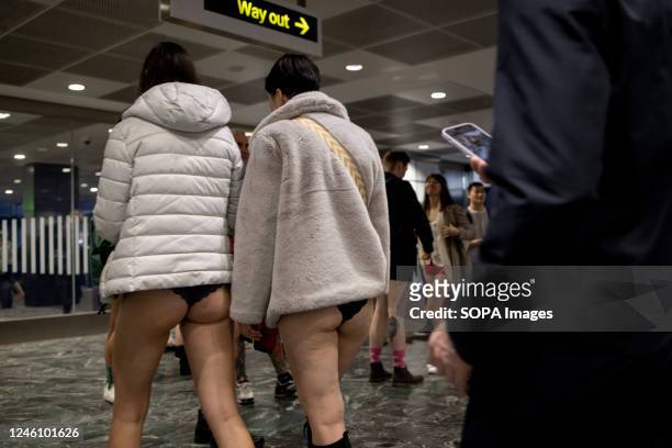 Participants of the "No Trousers Tube Ride" are seen walking inside the London Underground station. "No Trousers Tube Ride" returned to London since...