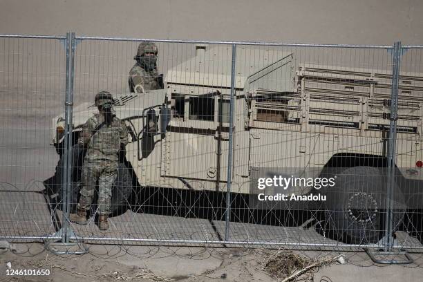 Texas National Guard soldiers stand guard as migrants continue to wait at the U.S.-Mexico border on January 08, 2023 in Ciudad Juarez, Mexico....