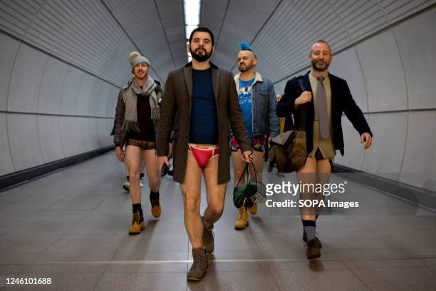 Participants of the "No Trousers Tube Ride" are seen walking inside the London Underground station. "No Trousers Tube Ride" returned to London since...