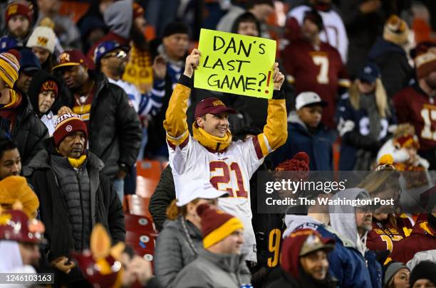 Washington Commanders fans holds a sign aloft during the game between the Washington Commanders and the Dallas Cowboys at FedEx Field on January 8,...