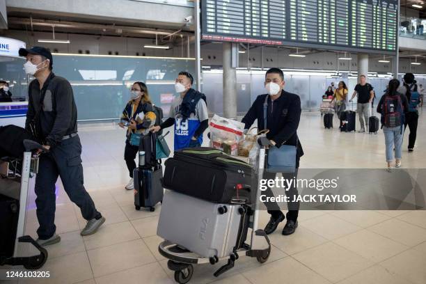 Travellers from a Xiamen Airlines flight arrive at Suvarnabhumi Airport in Bangkok on January 9 as China removed Covid-19 travel restrictions. China...