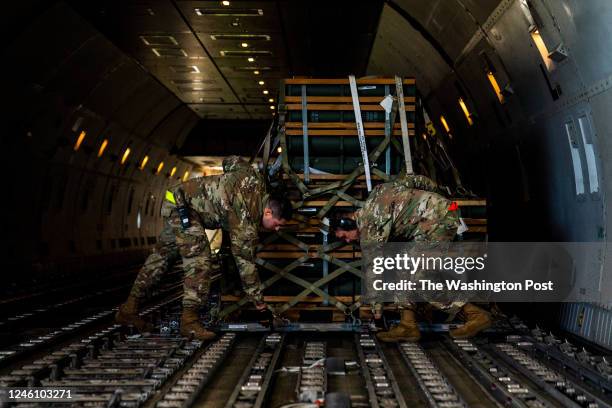 October 12, 2022: Airman lock pallets of ammunition, weapons and other equipment bound for Ukraine in place on a commercial airline at Dover Air...