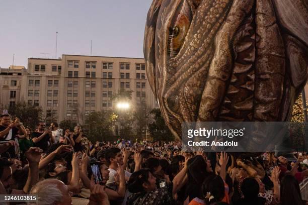 People watch the French parade play 'Saurian and the Witnesses of Outer Space' held by Les Plasticiens Volants at the International Festival "Teatro...
