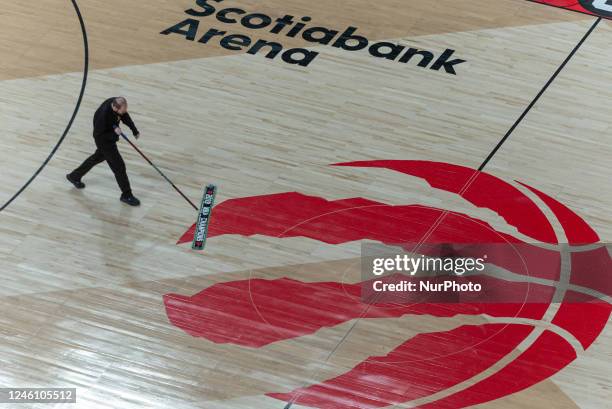 January 8, 2023: Man mopping the floor during timeout during the Toronto Raptors v Portland Trail Blazers NBA regular season game at Scotiabank Arena...