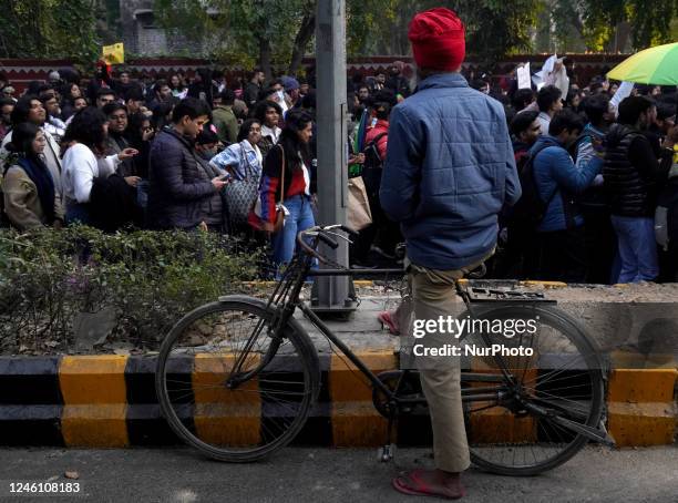 Man watches as participants and supporters of LGBTQ community take part in the annual Delhi Queer Pride March, an event promoting lesbian, gay,...