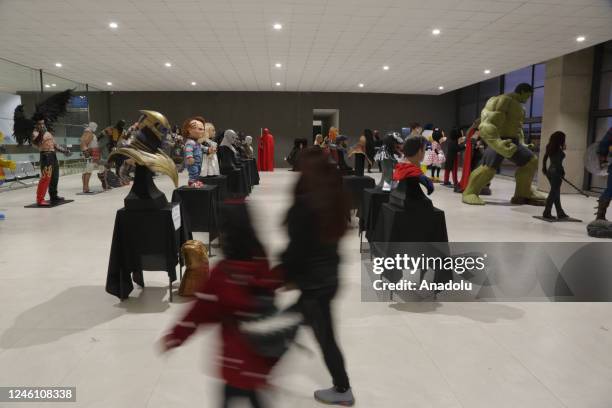 Girl and her mother walk in the middle of the sculptures of the exhibition "Mutante" by sculptor Ramiro Sirpa in La Paz, Bolivia on December 22,...